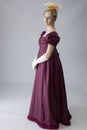 A young Regency woman in a an evening dress