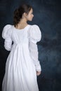 A young Regency woman wearing a white muslin dress and a pearl necklace Royalty Free Stock Photo