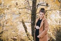 Young regnant woman posing in autumn park Royalty Free Stock Photo