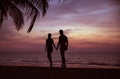 Young relaxed couple looking ath the calm ocean