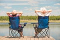 Young relaxed couple near a picturesque lake sitting