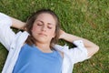 Young relaxed girl sleeeping on the grass