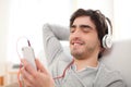 Young relaxed man listenning music in the sofa Royalty Free Stock Photo