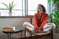 Young relaxed smiling pretty woman enjoying relaxing sitting on chair at home. Royalty Free Stock Photo