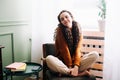 Young relaxed smiling pretty woman relaxing sitting on chair at home. Happy positive beautiful lady feeling joy enjoying wellbeing Royalty Free Stock Photo