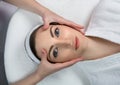 Young relaxing beautiful woman having facial massage Royalty Free Stock Photo