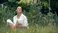 Young relaxing woman sitting in the grass