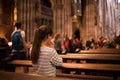 Girl in a church standing on her knees