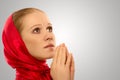 Young religious woman in a red shawl prays Royalty Free Stock Photo