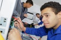 Young repairer working in computer service center