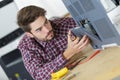 Young repairer working with screwdriver in service center