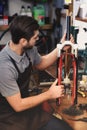 young repairman in apron working with bicycle