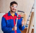 Young repairman carpenter working with clamps