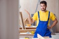 The young repairman carpenter working cutting wood Royalty Free Stock Photo