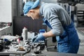 Young repairman doing restoration of old details for car