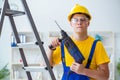 The young repairman with power drill Royalty Free Stock Photo