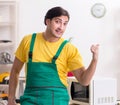 Young repairman repairing microwave in service centre Royalty Free Stock Photo