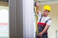 The young repairman with tape measure working on repairs Royalty Free Stock Photo