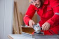 The young repairman working with a grinding wheel Royalty Free Stock Photo