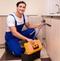 Young repairman working at the kitchen Royalty Free Stock Photo