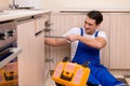 The young repairman working at the kitchen Royalty Free Stock Photo