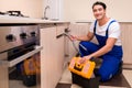 The young repairman working at the kitchen Royalty Free Stock Photo