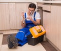 Young repairman working at the kitchen Royalty Free Stock Photo