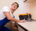 Young repairman working at the kitchen Royalty Free Stock Photo