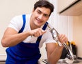 Young repairman working at the kitchen Royalty Free Stock Photo