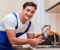 Young repairman working at the kitchen Royalty Free Stock Photo