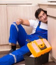 Young repairman working at the kitchen Royalty Free Stock Photo