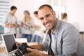 Young reporter working at office on laptop