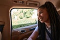 Young resilient female passenger enjoying car travel