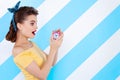 Young retro pinup woman on colorful background
