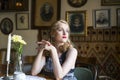 Young retro woman sitting at a table. Royalty Free Stock Photo