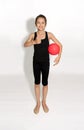 Young rhythmic gymnast with ball, gesturing by thumbs up a good mood, happy sportive childhood.
