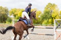 Young rider girl jumping over barier on her course Royalty Free Stock Photo