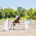 Young rider girl jumps on show jumping competition Royalty Free Stock Photo