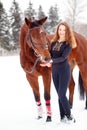 Young rider girl stand with horse in winter park Royalty Free Stock Photo