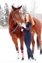 Young rider girl stand with horse in winter park Royalty Free Stock Photo