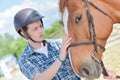 Young rider with horse Royalty Free Stock Photo