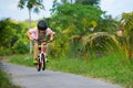 Young rider kid in helmet and sunglasses riding bicycle