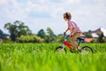 Young rider kid in sunglasses riding bicycle