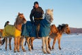 Young riders came to make their horses drink at a hole dug in the lake