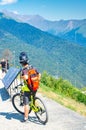 Sochi, Russia - august 19, 2018: Young road biker taking a break from a climb exploring a map of the area