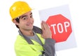 Road worker holding a stop sign.