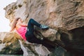 Young rock climber woman climbing the rock wall