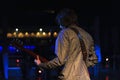 Young rock singer on stage playing guitar