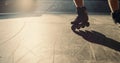 Young roller skater practicing stunt at skate park. Man legs in roller skates. Royalty Free Stock Photo