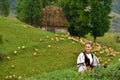 Young Romanian girl smiling, old shepherd house in the background